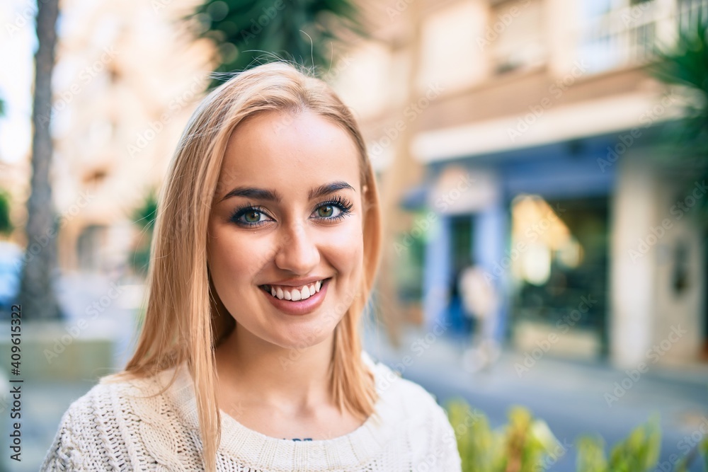 Young blonde girl smiling happy standing at the city. Young blonde girl smiling happy standing at the city.