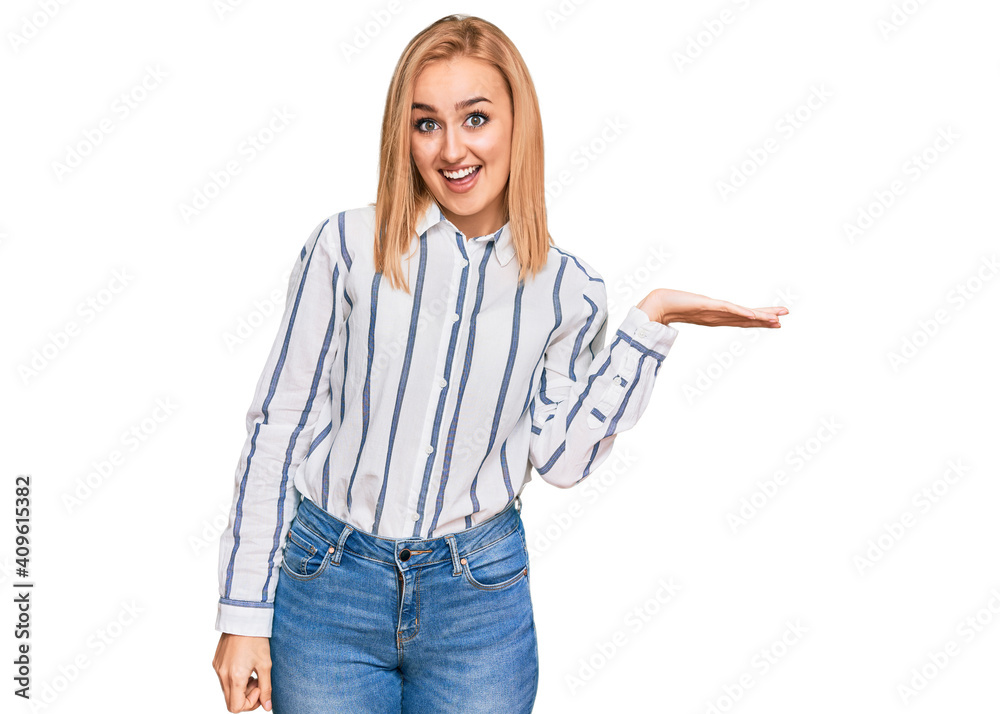 Beautiful caucasian woman wearing casual clothes smiling cheerful presenting and pointing with palm of hand looking at the camera. Beautiful caucasian woman wearing casual clothes smiling cheerful presenting and pointing with palm of hand looking at the camera.