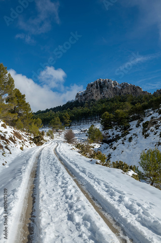 Mountain road to La Serrella (1.359 m) mountain in winter with snow, Confrides village, Province of Alicante, Costa Blanca, Spain