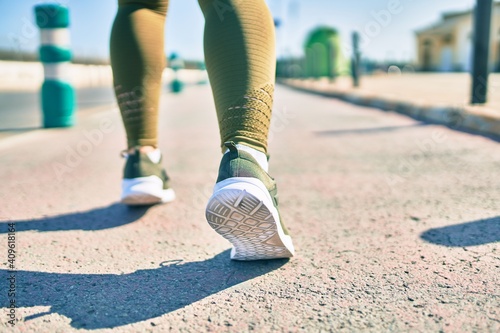 Tableau sur toile Sportswoman wearing sportswear running at the city.