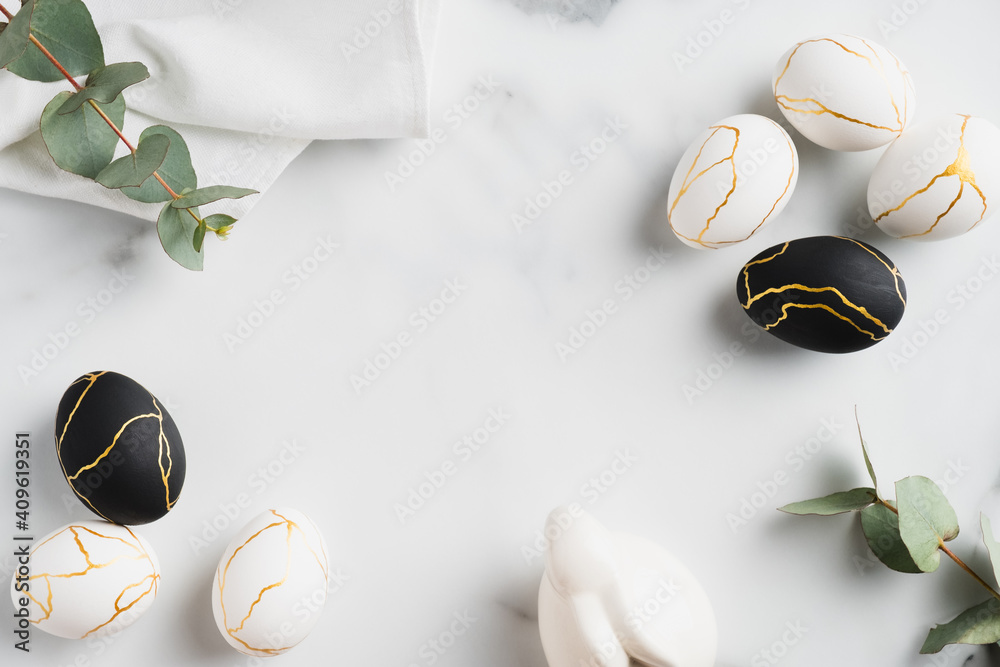 Luxury Easter flat lay composition with black and golden eggs, eucalyptus leaves, bunny rabbit, towel on marble table. Happy Easter concept. Top view. - obrazy, fototapety, plakaty 