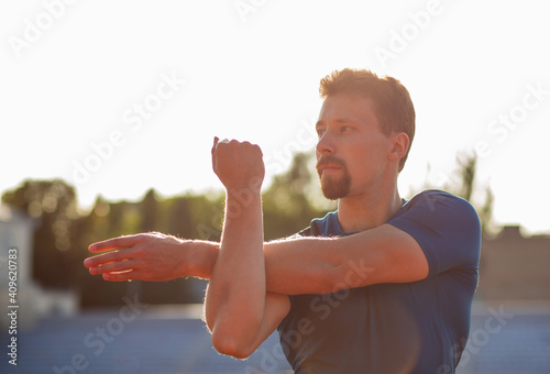 Fototapeta Naklejka Na Ścianę i Meble -  Handsome guy doing stretching before running