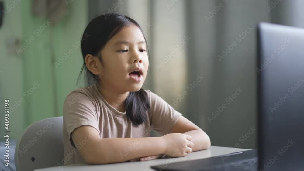 Asian child student or kid girl enjoy talk or singing on computer notebook for e-learning communication or study online and people learn from home to playing laptop for education by back to school 4K