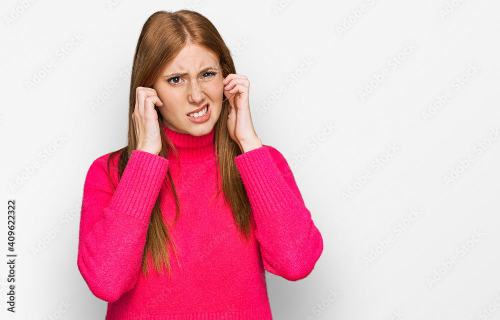 Young irish woman wearing casual clothes covering ears with fingers with annoyed expression for the noise of loud music. deaf concept. Young irish woman wearing casual clothes covering ears with fingers with annoyed expression for the noise of loud music. deaf concept.