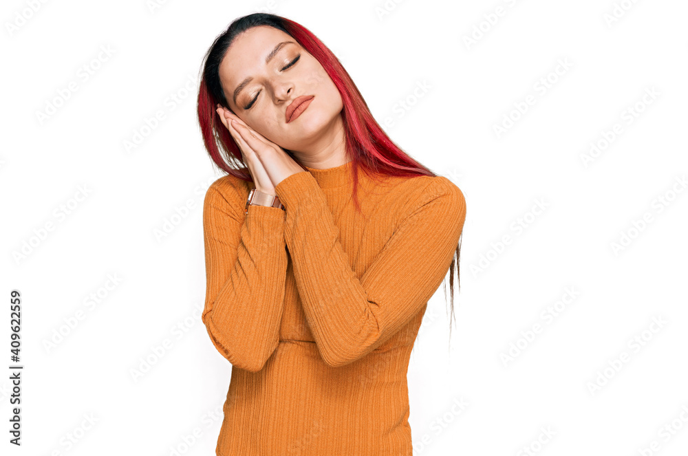 Young caucasian woman wearing casual clothes sleeping tired dreaming and posing with hands together while smiling with closed eyes. Young caucasian woman wearing casual clothes sleeping tired dreaming and posing with hands together while smiling with closed eyes.