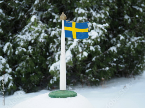 Photography Swedish flag in winter. National symbol. Trip to Sweden.