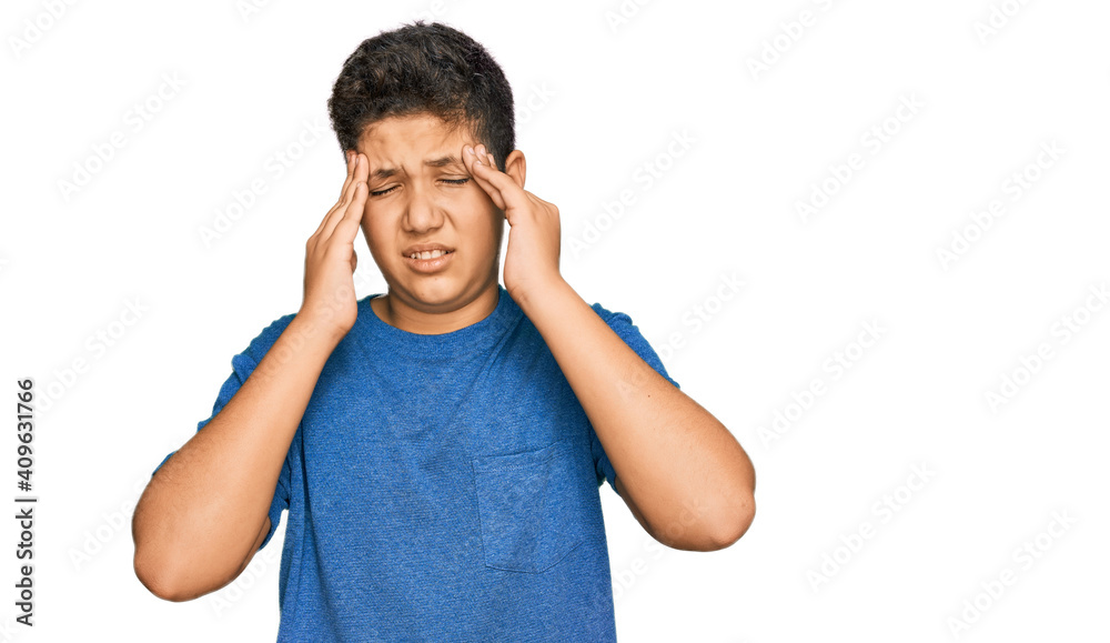 Fototapeta premium Teenager hispanic boy wearing casual clothes with hand on head for pain in head because stress. suffering migraine.