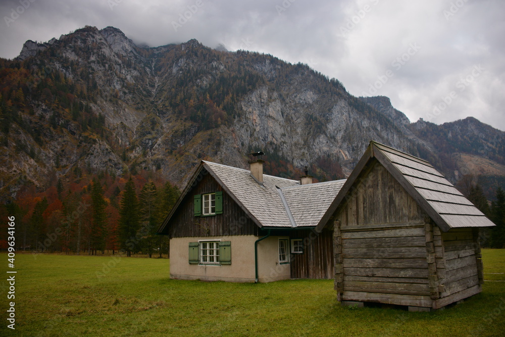 Old house in the mountains and a wooden shed