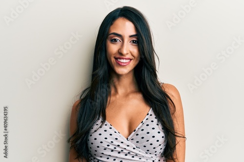 Beautiful hispanic woman wearing casual clothes looking positive and happy standing and smiling with a confident smile showing teeth
