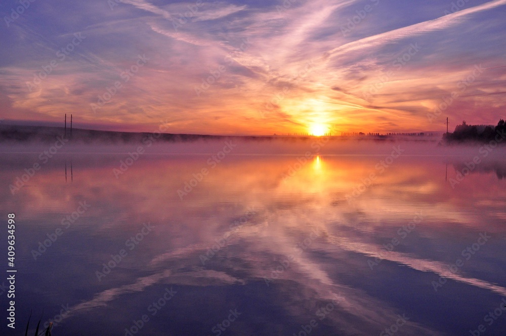 Misty beautiful sunrise over water