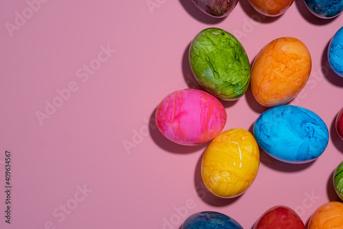 Boiled chicken painted eggs on a pink background.