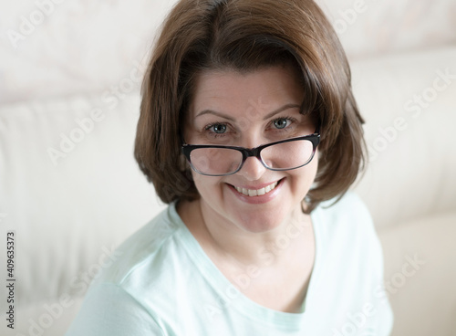 Portrait of a woman with glasses in home interior