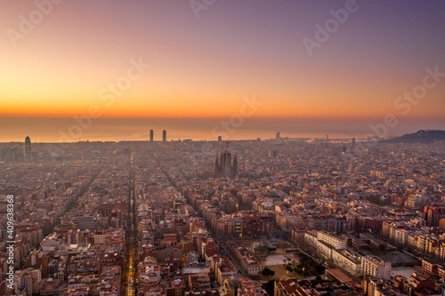 Aerial drone shot of Barcelona city before sunrise golden hour © Davidzfr