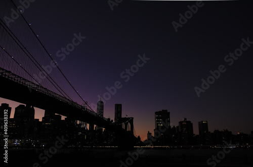 Brooklyn bridge and lower manhattan at night after sunset with colorful skies © Rana Khoury