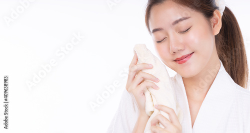 Beauty, cosmetics, healthy, treatment, skincare and spa concept. Asian young woman using white towel clean own face clear fresh skin. Teenager removing makeup off skin over isolated white background.