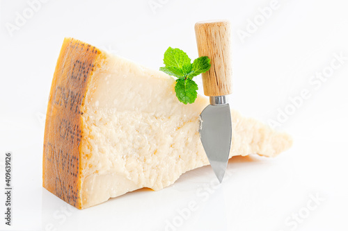 Large pies of parmesan cheese on white background
