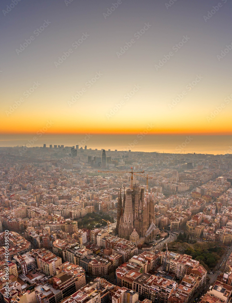 Aerial drone shot of Barcelona city center sea horizon before sunrise golden hour