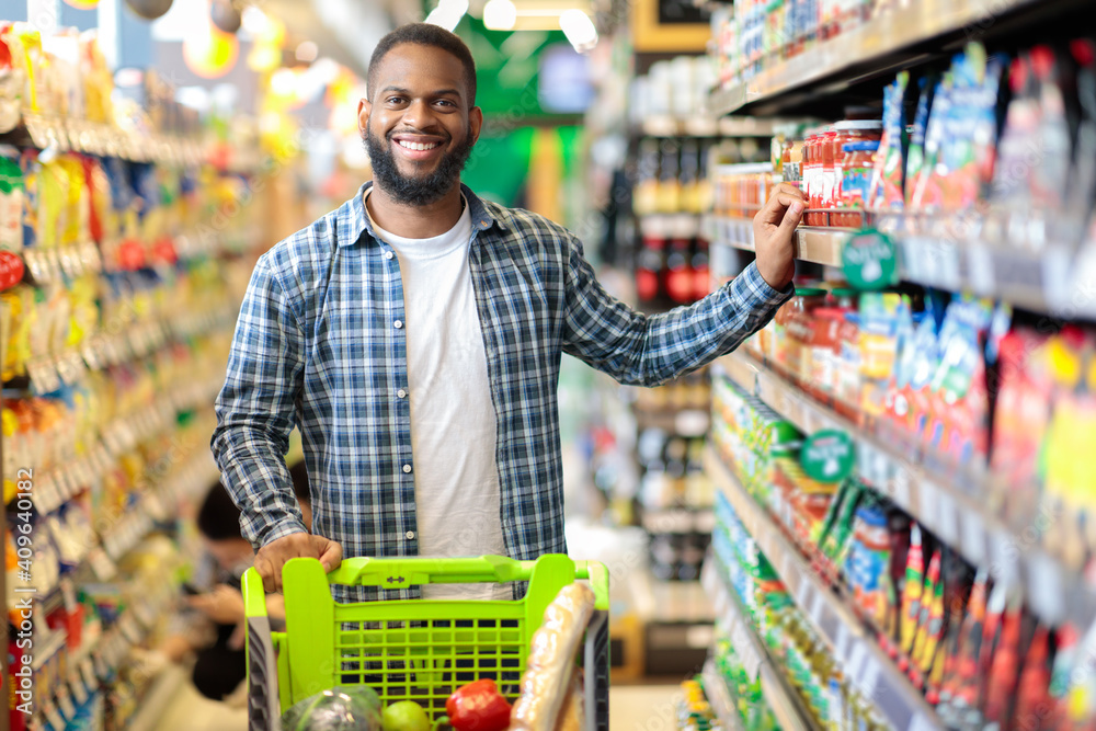 Happy African American Guy Posing In Supermarket, Smiling To Camera ...