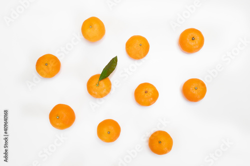 Fruit pattern of fresh orange tangerine or mandarin isolated on white background. Flat lay, top view. Citrus in minimal style © Tatsiana