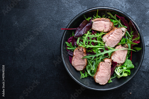 salad duck breast mix greens lettuce leaves ready to eat portion on the table for healthy meal snack outdoor top view copy space for text food background rustic image keto or paleo diet