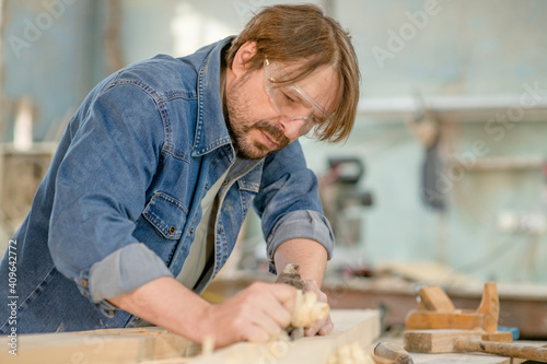 Carpenter planed wood in a workshop