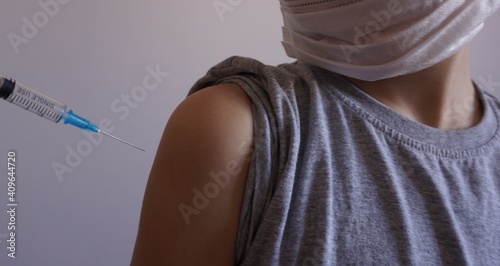Vaccination of children from covid. Doctor injects vaccine in a patient's shoulder. Close up. For medical publications, immunization and vaccination campaign of people against infection