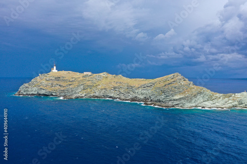 Drone view from  île de la Giraglia on the northern tip of Cap Corse, famous for its lighthouse and Genoese tower, both of which are historical monuments. Barcaggio village, Corsica, France photo