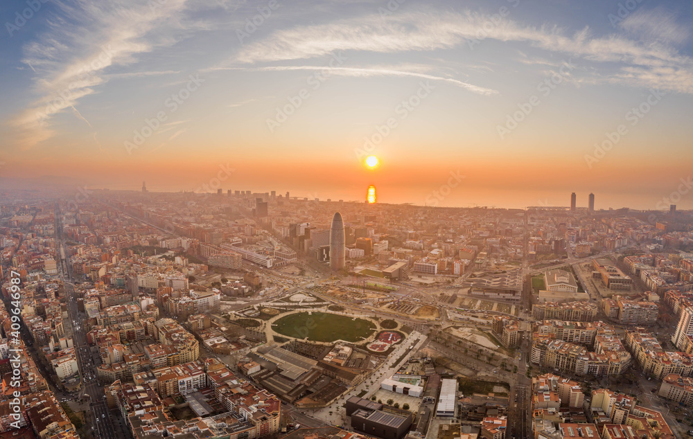 Aerial drone shot of agbar tower by Barcelona beach with sunrise