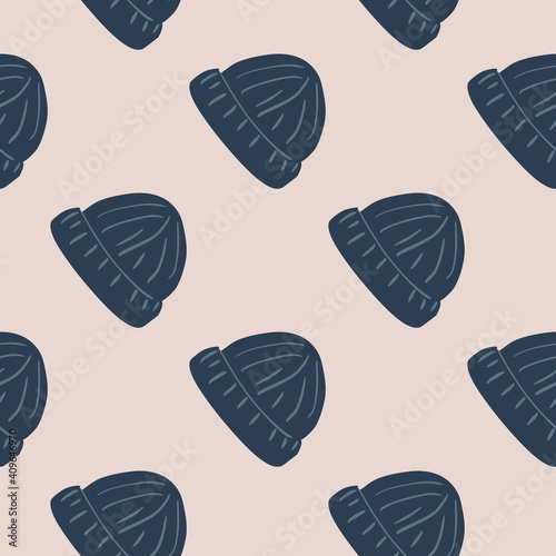 Navy blue doodle beanie hat ornament seamless pattern in hand drawn style. Light pink background.