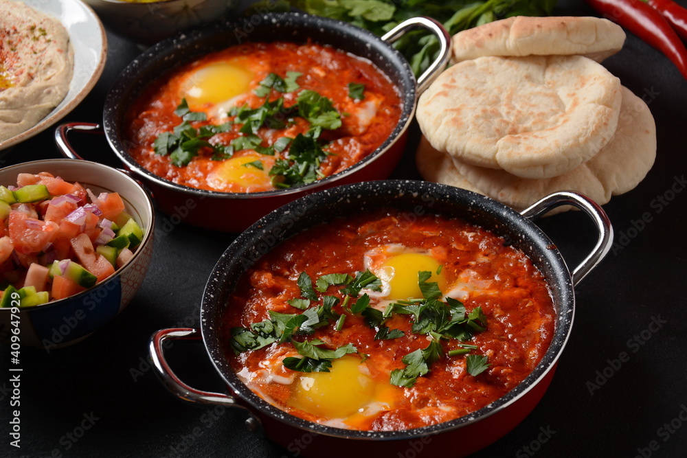 Shakshouka, eggs poached in sauce of tomatoes, olive oil, peppers, onion and garlic, Mediterranean cuisine