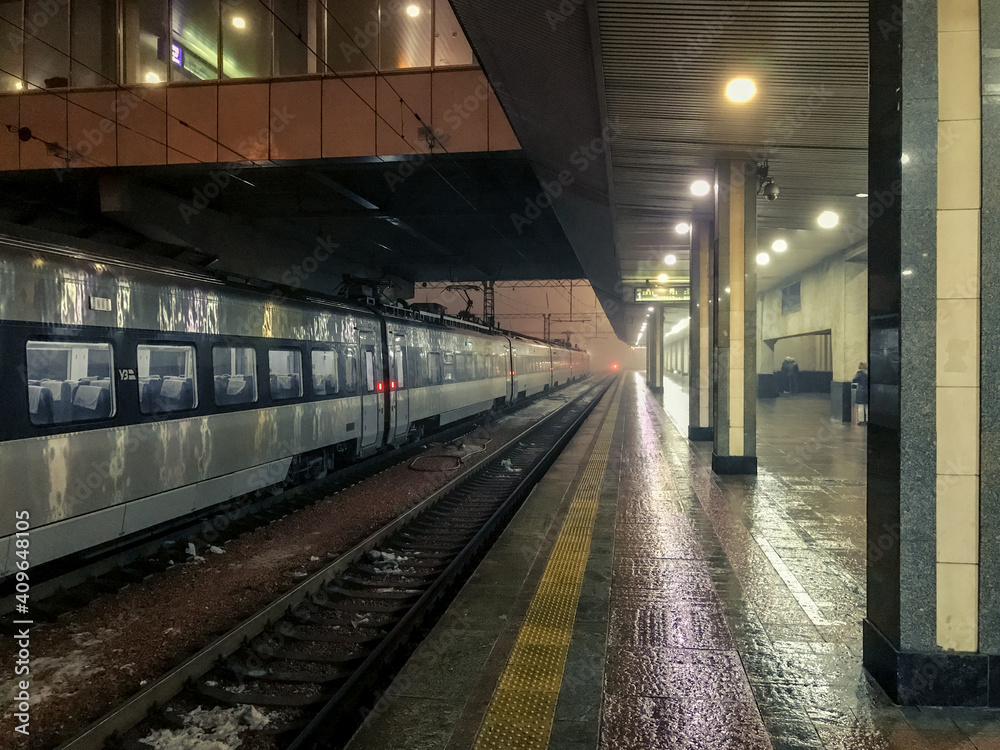 Kiev Central Railway Station. Empty platform and train on rails at night Kiev Central Railway Station. Empty platform and train on rails at night