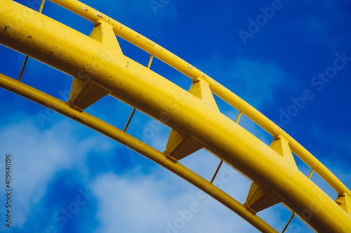 detail view of roller coaster against blue sky