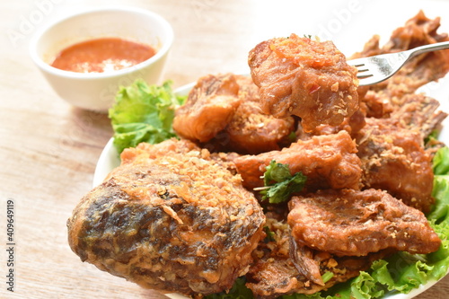 batter fried slice mango or red Tilapia fish with chop garlic dipping spicy sauce