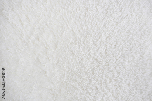 Abstract white background. Fluffy fur rug. Wool surface texture.