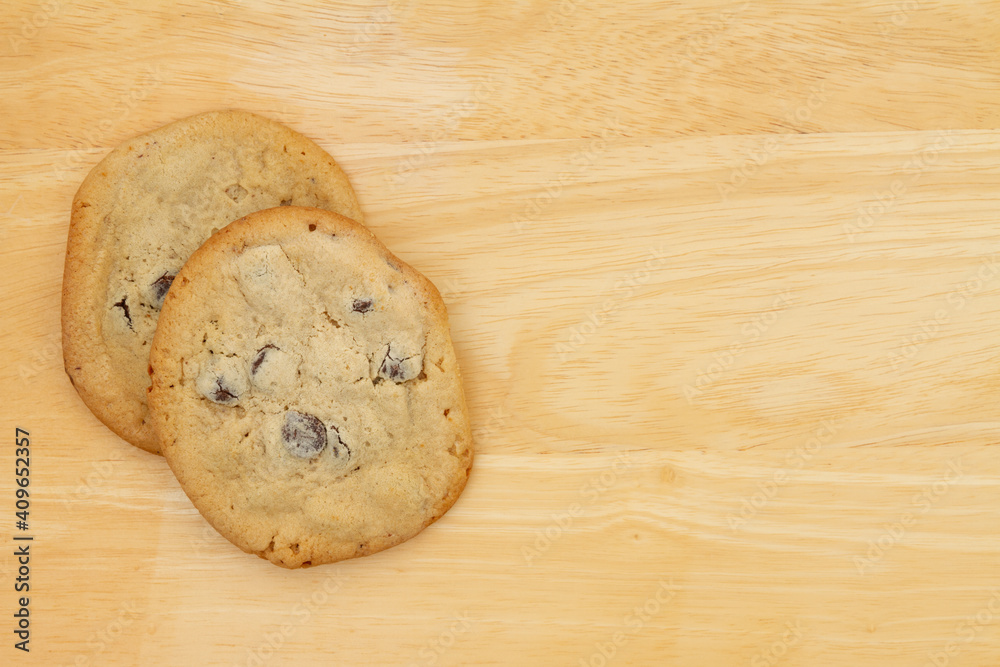 Home-made chocolate chip cookies on a wood table Home-made chocolate chip cookies on a wood table