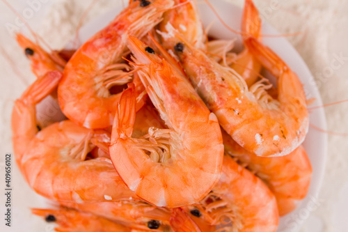 beautiful large boiled tiger prawns on a white plate on the kitchen table