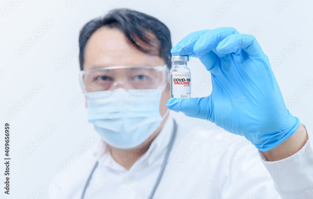 Concept fight against virus covid-19 corona virus, Young doctor or scientist in gown shirt holding COVID-19 vaccines. Concept fight against virus covid-19 corona virus, Young doctor or scientist in gown shirt holding COVID-19 vaccines.