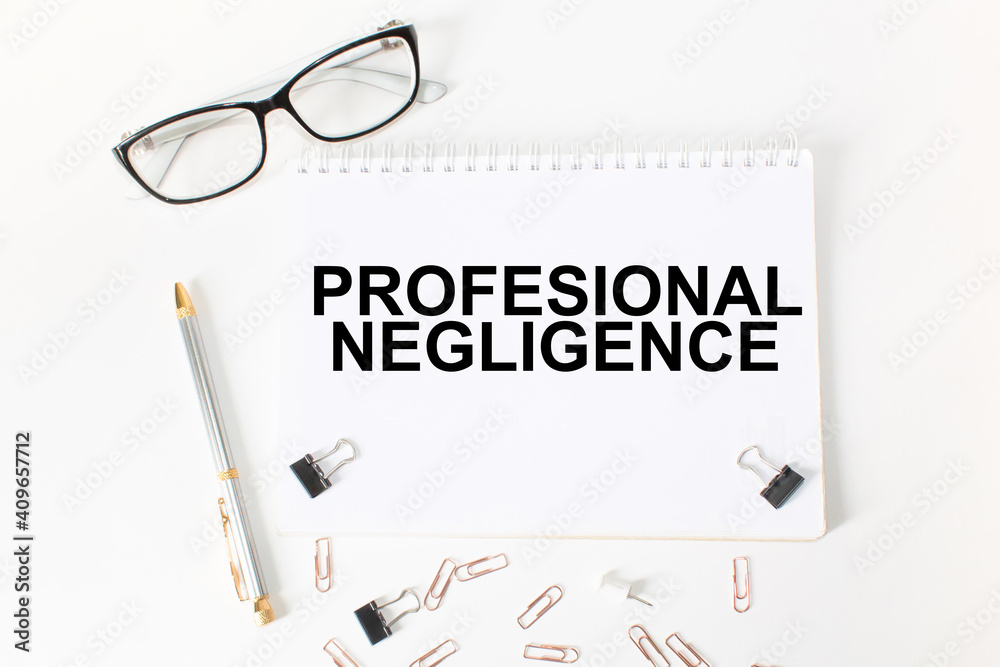 Notepad with inscriptions PROFESSIONAL NEGLIGENCE on a white background. business concept. Notepad with inscriptions PROFESSIONAL NEGLIGENCE on a white background. business concept.