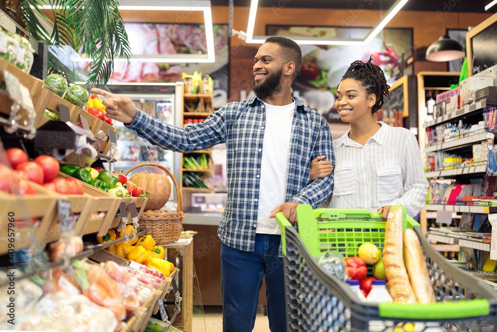 Grocery Shopping In Supermarket, African American Spouses Buying Fruits Indoors