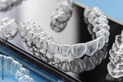 Invisalign braces or invisible retainer black reflective background