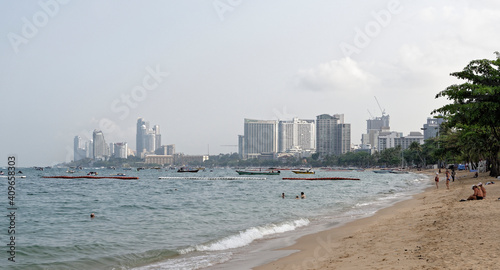 Pattaya Beach. People sit on the sand, some swim in the sea