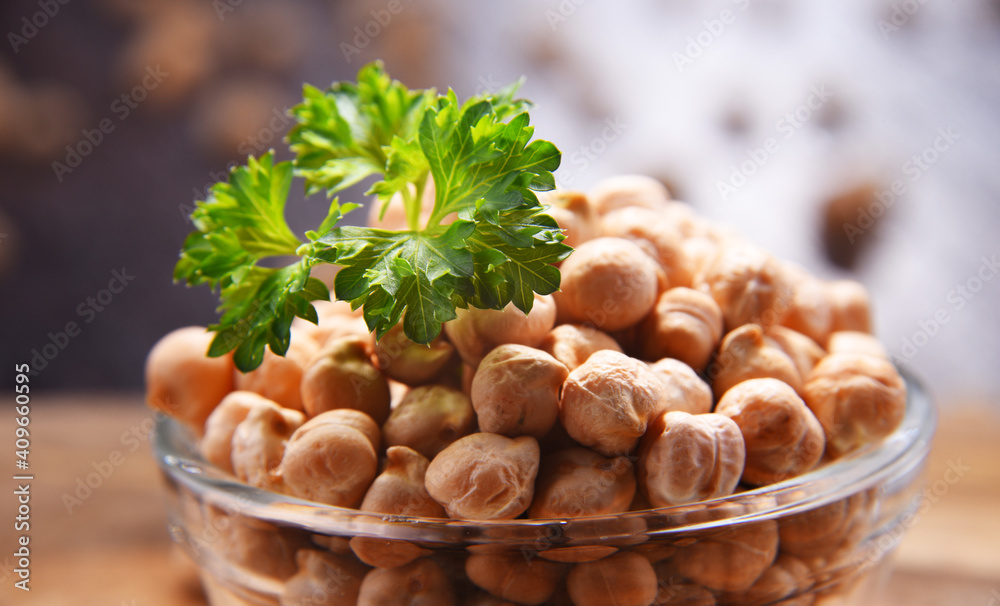 Composition with bowl of chickpeas on wooden table