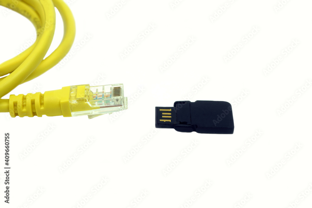 Close-UP a RJ-45 connector with a USB flash drive on white grounds. Close-UP a RJ-45 connector with a USB flash drive on white grounds.