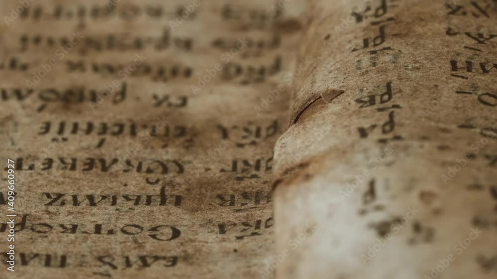 Background of book with ancient writings, mystical secrets of past, mysteries of history. Slider shot macro view of religious literature, archival manuscripts