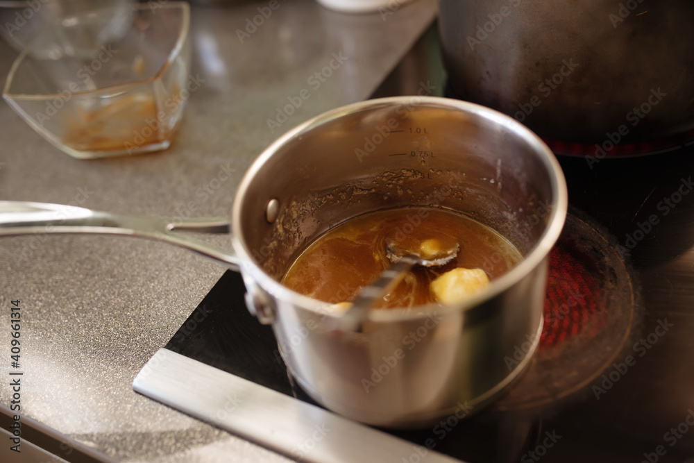 honey and butter are melted in a saucepan on the stove in kitchen honey and butter are melted in a saucepan on the stove in kitchen