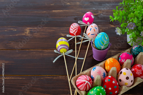 colorful painted egg in basket on wooden table prepare for celebrate easter day