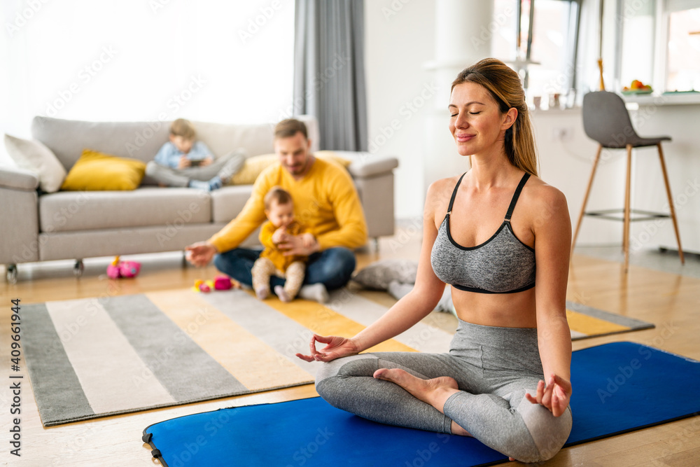 Active sportswoman exercising and smiling at home Active sportswoman exercising and smiling at home