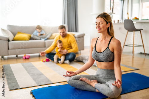 Active sportswoman exercising and smiling at home