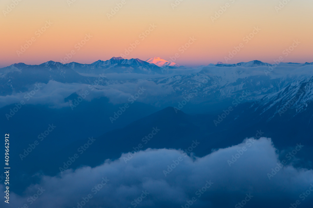 Mountain view at sunset. Mount Elbrus is visible on the horizon Mountain view at sunset. Mount Elbrus is visible on the horizon