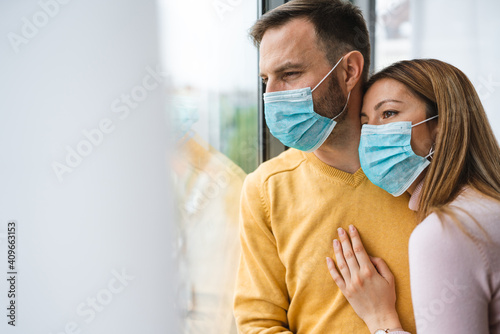 Home isolation during coronavirus quarantine. Man and woman wearing face mask. Stay home.